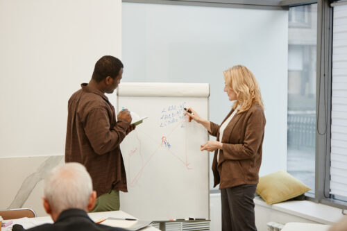 Woman showing her colleague a presentation on security controls